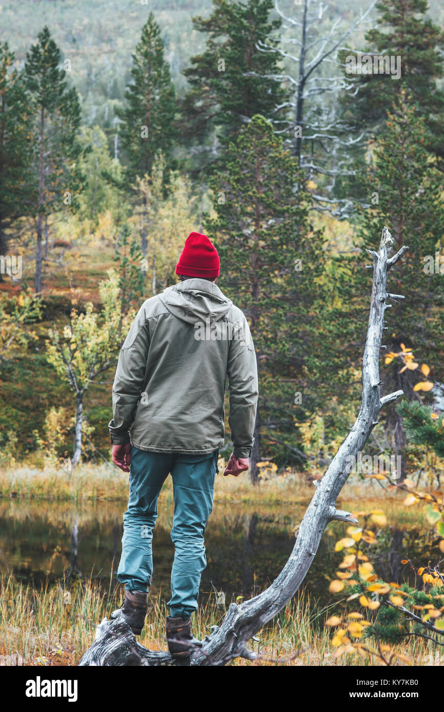 L'uomo traveler in foresta scandinava di viaggio il concetto di stile di vita la sopravvivenza nel selvaggio vacanze indossando Red Hat Foto Stock