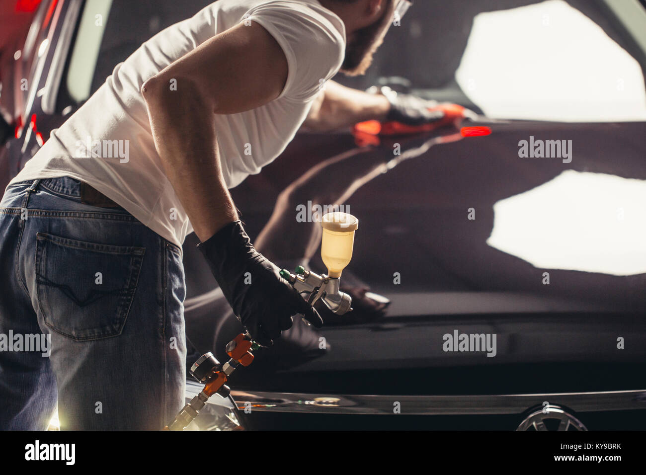 Uomo Macchina di pulizia con un panno in microfibra, auto che dettaglia o concetto valeting Foto Stock