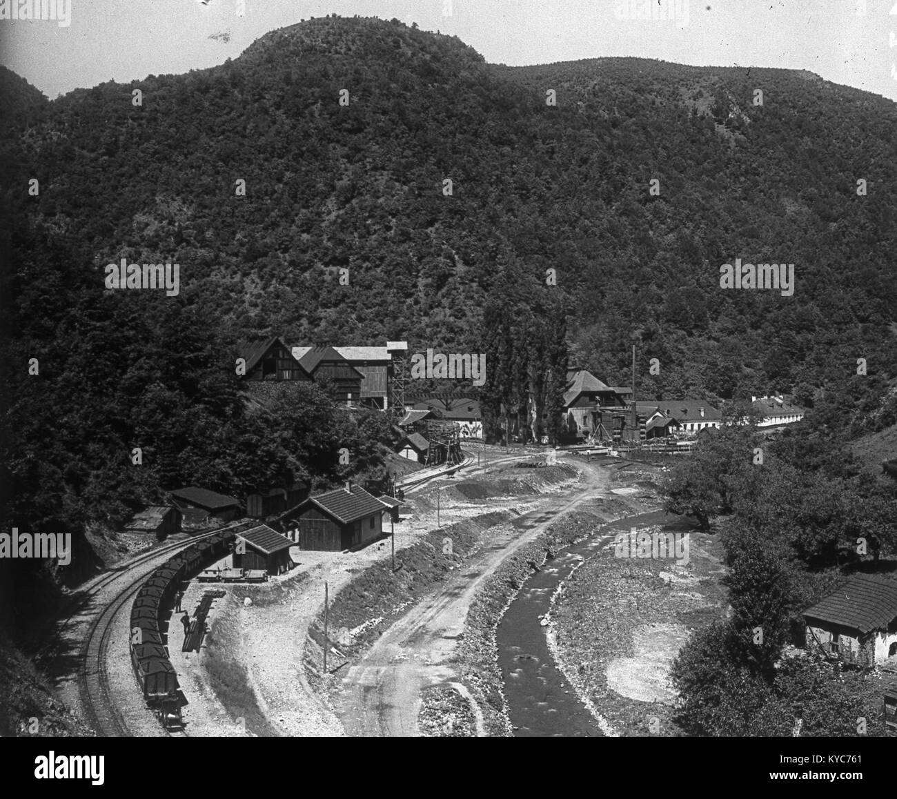 L'immagine intitolata “Pályaudvar, háttérben a vasgyár” (stazione con lavorazione del ferro sullo sfondo) fa parte dell'archivio fotografico storico ungherese Fortepan e raffigura una stazione ferroviaria con un impianto siderurgico dietro di essa. Questo tipo di scena illustra l'interazione tra ferrovie e industria pesante nell'Ungheria del XX secolo. 24.hu+1 Foto Stock