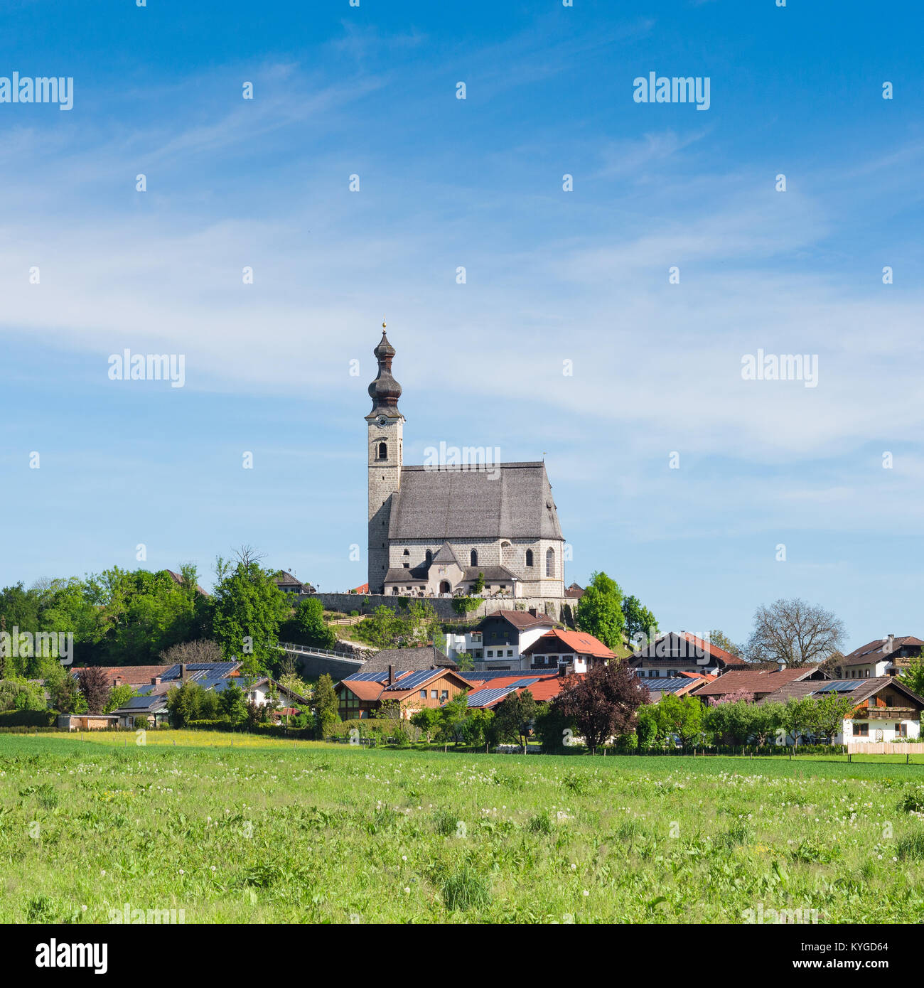 La molla paesaggio rurale con la Chiesa Cattolica e il piccolo villaggio bavarese. Square stock photo. Foto Stock