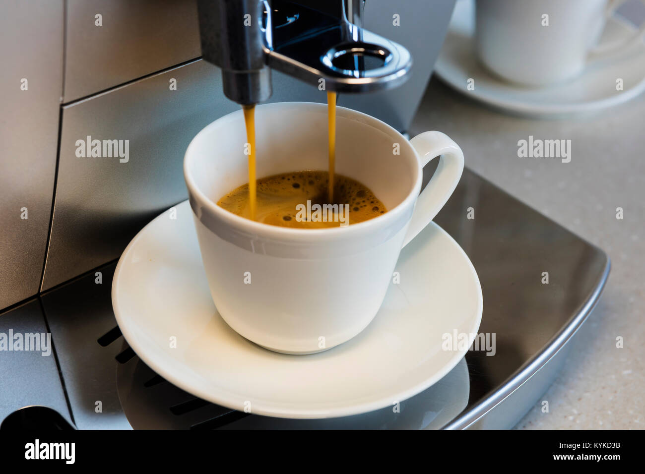 Macchina da caffè la preparazione di caffè espresso in una piccola tazza di ceramica. Foto Stock