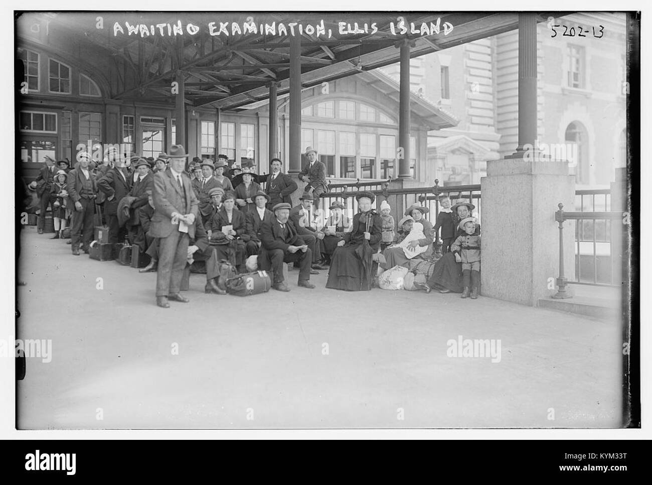 Una fotografia storica di immigrati in attesa di un esame a Ellis Island, scattata per la Biblioteca del Congresso, che mostra le persone in una foto in stile vintage. Foto Stock
