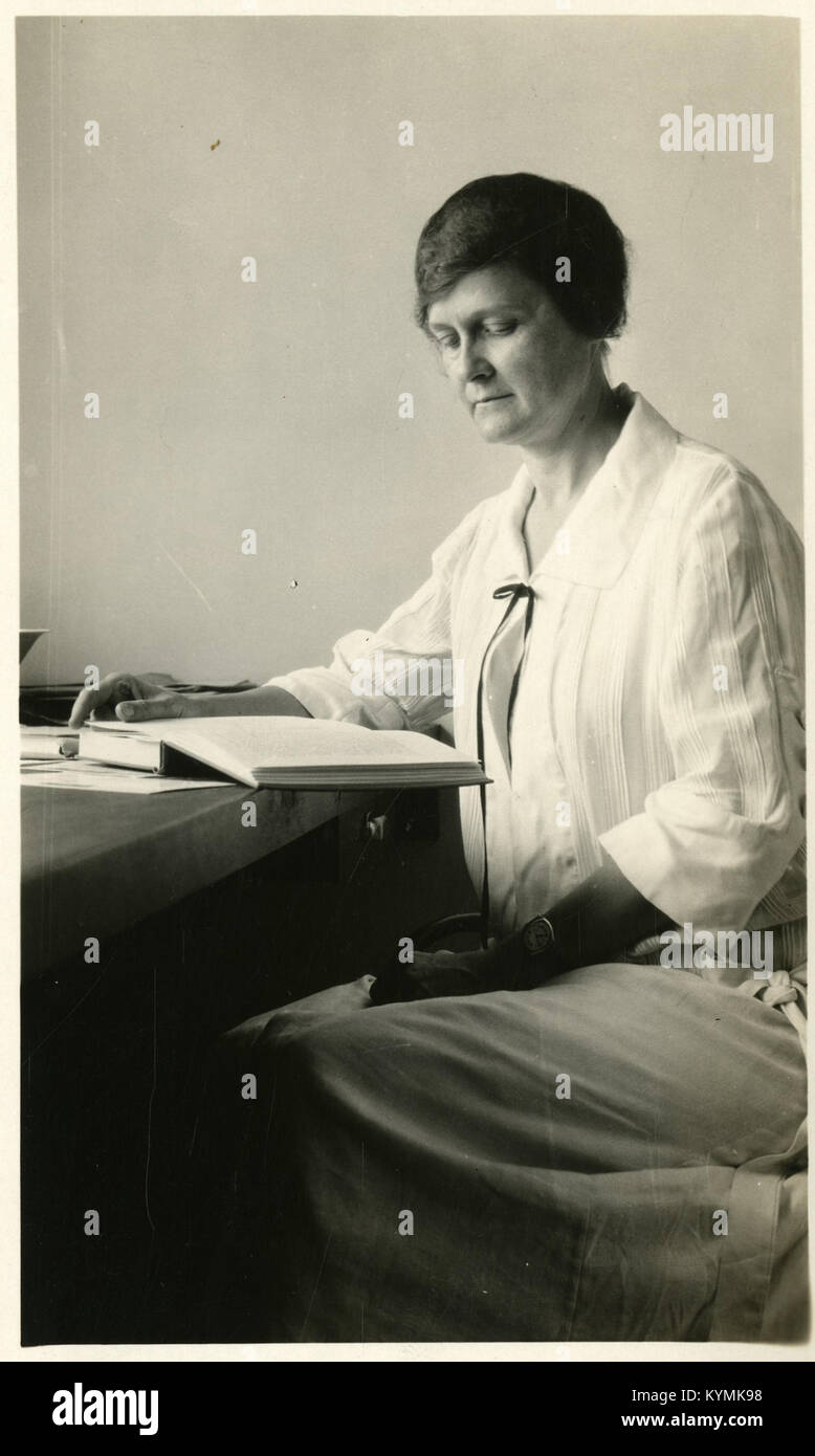 Un'illustrazione storica di Mary Stuart MacDougall, una figura di spicco nella biologia dell'inizio del XX secolo, seduta con un libro di testo. L'immagine fa parte della collezione Smithsonian Institution Archives ed evidenzia i contributi delle donne nella scienza durante la celebrazione del mese della storia delle donne del 2013. Questa foto vintage cattura un momento nella storia scientifica, riflettendo il suo lavoro nel campo della citologia e della zoologia. Foto Stock
