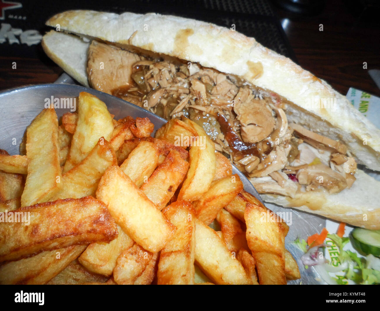 Hot il tacchino arrosto, ripieno e salsa di mirtilli con il sugo di carne in una baguette e un lato della fecola di patate fritte/chips Foto Stock