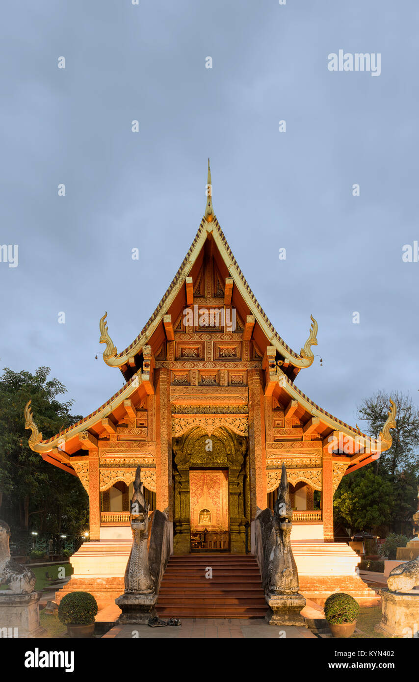 Un temle illuminato al Wat Phra Sing in Chiang Mai Thailandia su un nuvoloso e fresco Gennaio sera. Foto Stock