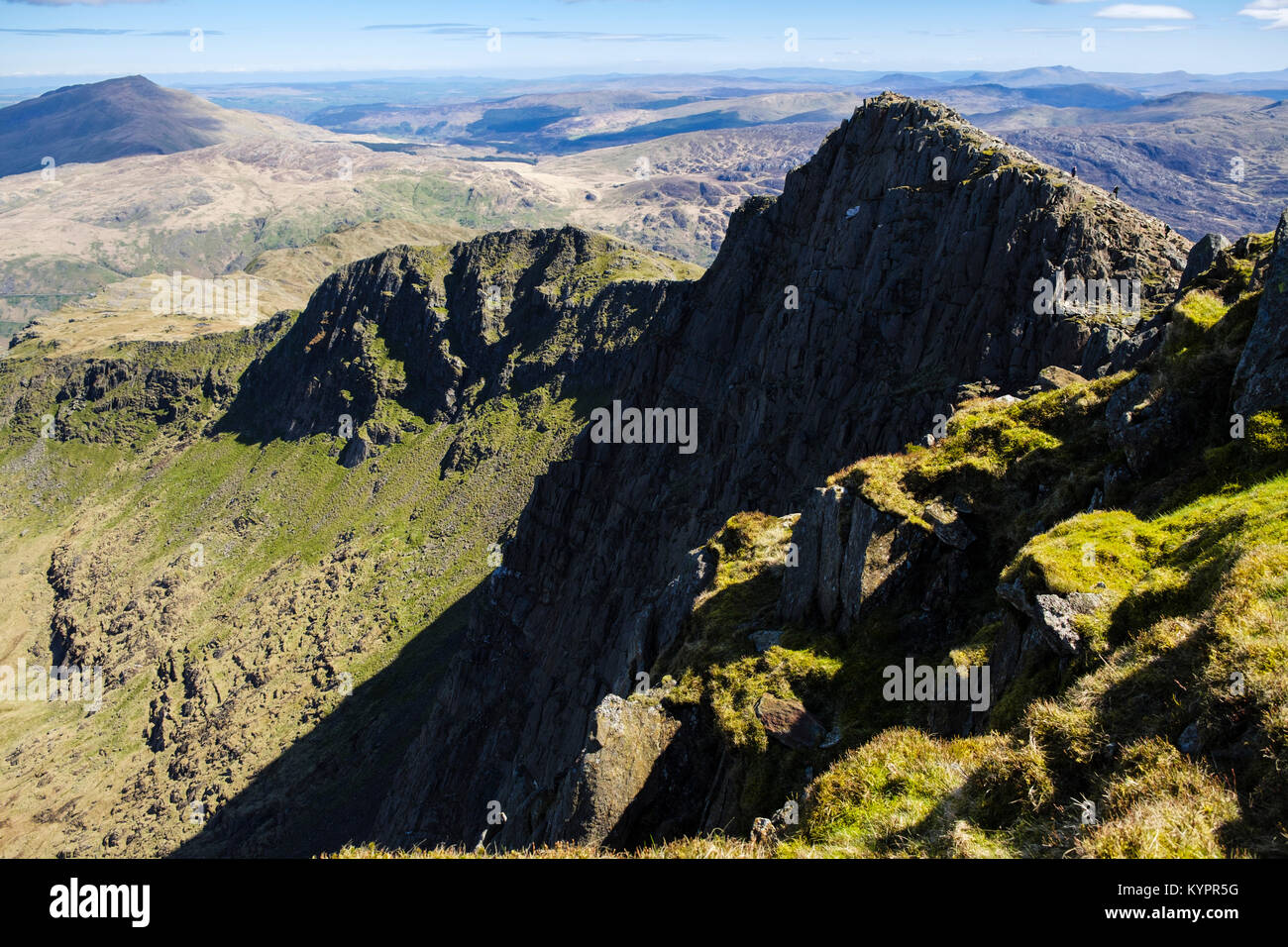 Vista est a Y Lliwedd erte picco di montagna con gli escursionisti su Snowdon horseshoe nelle montagne del Parco Nazionale di Snowdonia, Wales, Regno Unito, Gran Bretagna Foto Stock