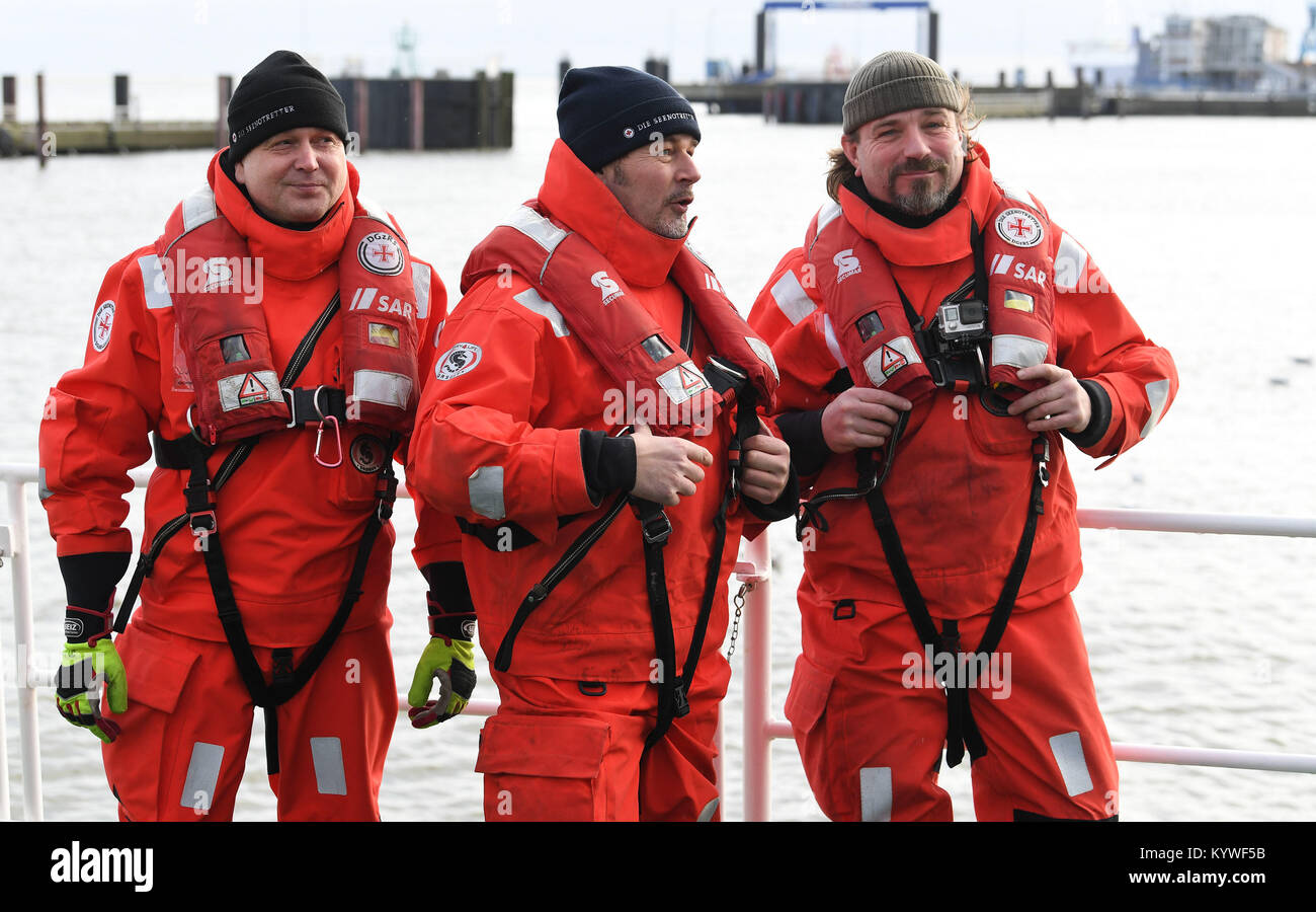 Cuxhaven, Germania. 16 gennaio, 2018. Attore fino a Demtroeder, nuova embassador del tedesco di ricerca ed il salvataggio marittimo Service (DGzRS) pone con membri di equipaggio Domenik Holtmeier (L) e Sven Wittko (R) sul ponte del mare la barca di salvataggio "Hermann Marwede' indossando tute di sopravvivenza in Cuxhaven, Germania, 16 gennaio 2018. Il DGzRS è presentare il loro bilancio annuale per il 2017. Credito: Carmen Jaspersen/dpa/Alamy Live News Foto Stock