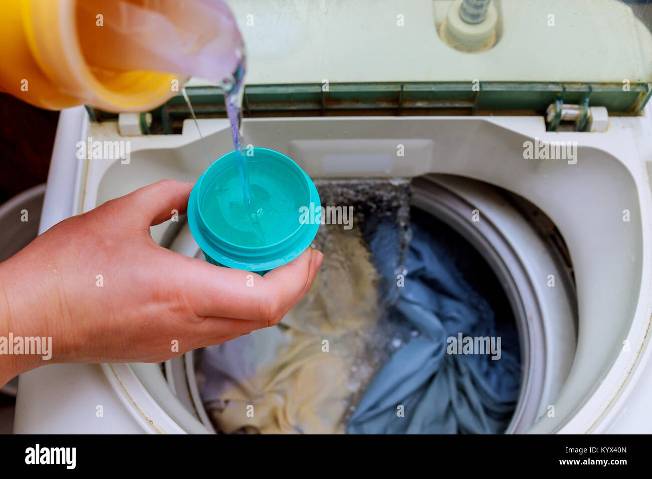 Donna mano versando la polvere di lavaggio in lavatrice polvere di lavaggio  in lavatrice Foto stock - Alamy