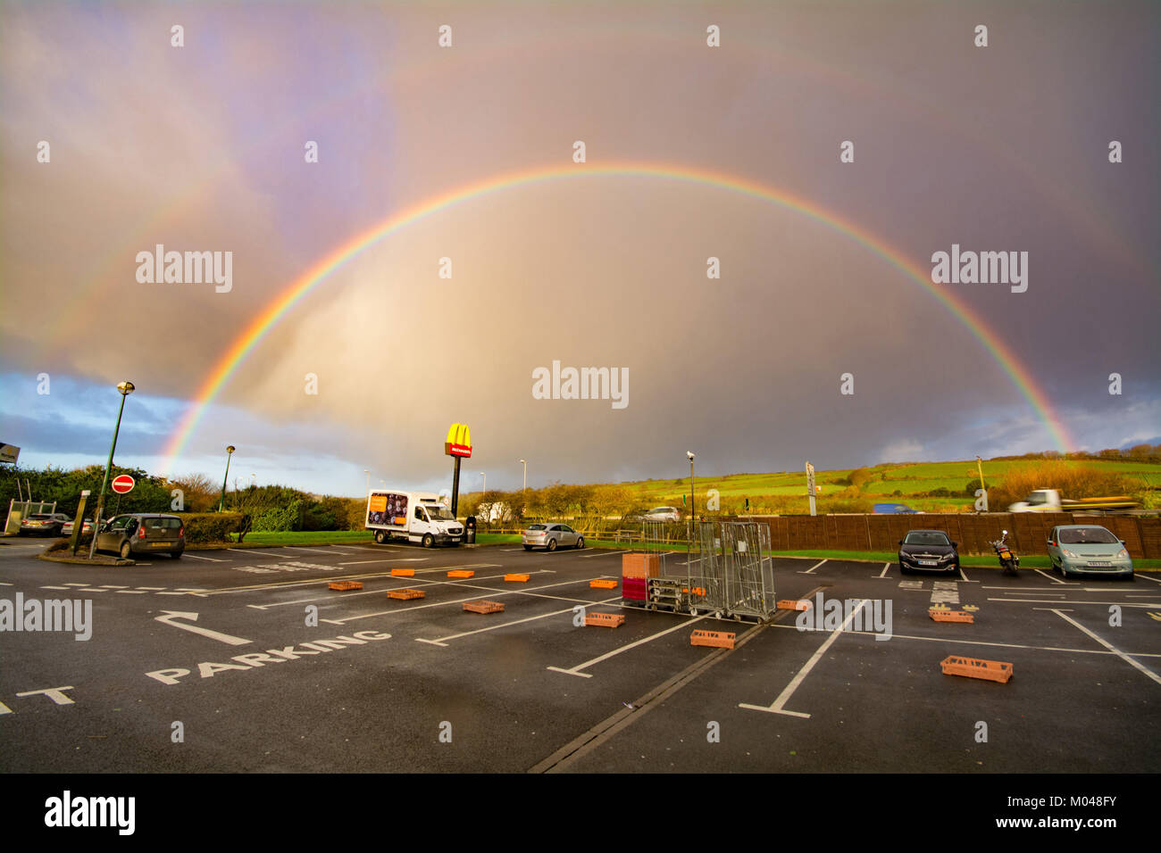 Un doppio arcobaleno oltre il segno Mcdonalds Foto Stock