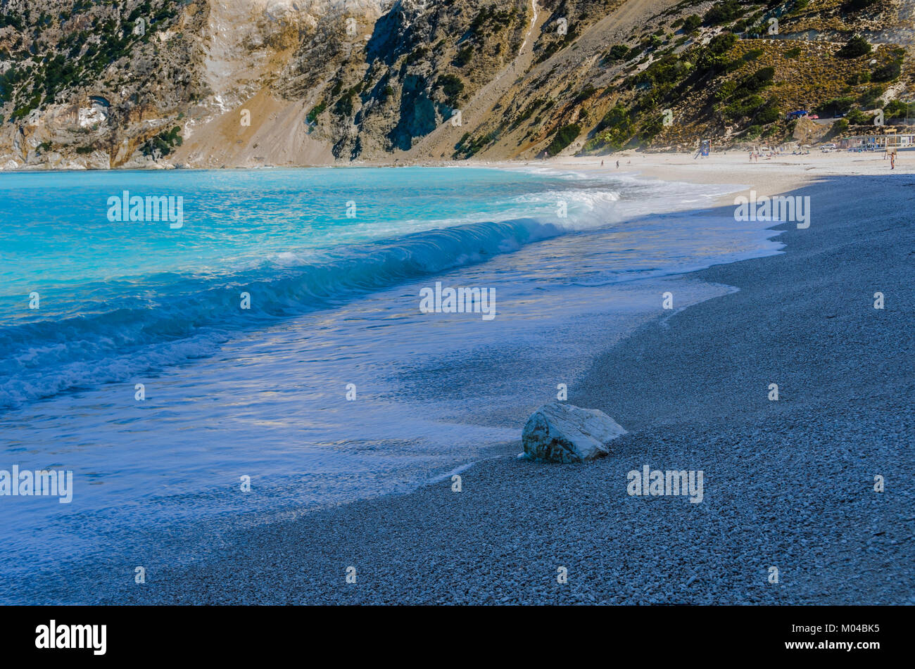 Pietre ghiaia e infine la polvere che trasforma il mare in turchese nella paradisiaca spiaggia di Myrtos circondato da montagne di Cefalonia Foto Stock