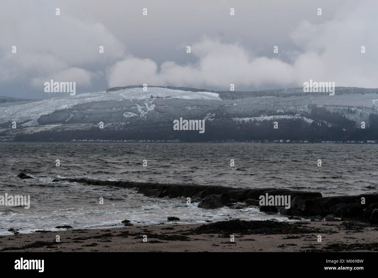 Inverno nuvole sopra il Cowal Peninsula come visto dalla spiaggia Inverkip Foto Stock