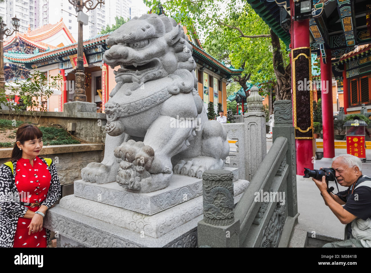 Cina, Hong Kong Kowloon, Wong Sai tempio dello stagno, Lion statua, turisti cinesi e la statua di Lion Foto Stock