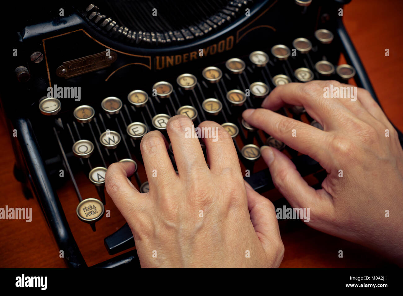 Donna digitando su una meccanica antica macchina da scrivere Underwood Foto Stock