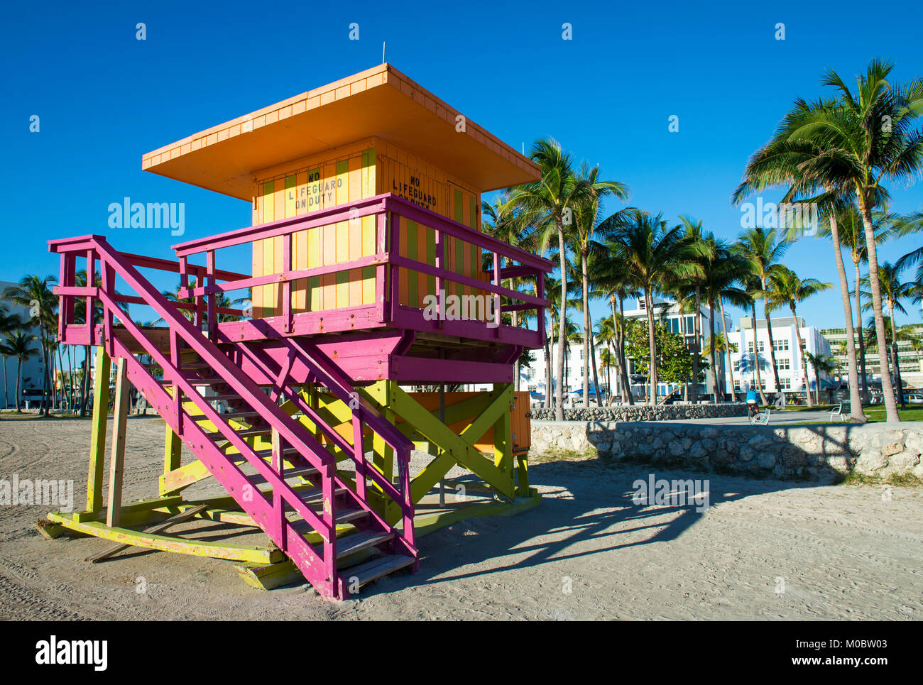 Luminose scenic vista la mattina di un iconico di rosa pastello torre bagnino permanente nel vuoto Lummus Park sulla spiaggia di South Beach a Miami in Florida Foto Stock