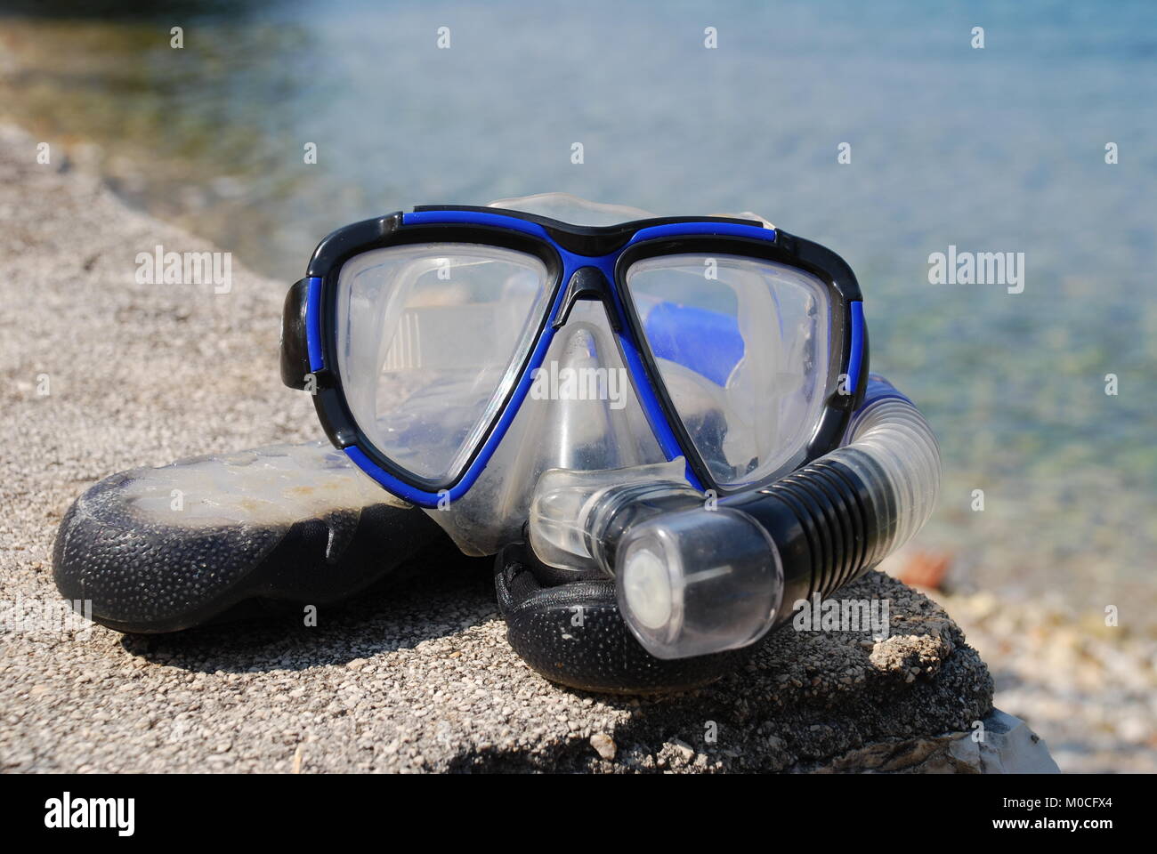 Un boccaglio e maschera e sulla spiaggia di ciottoli a Spartohori sull'isola greca di Meganisi il 31 agosto 2008. Foto Stock