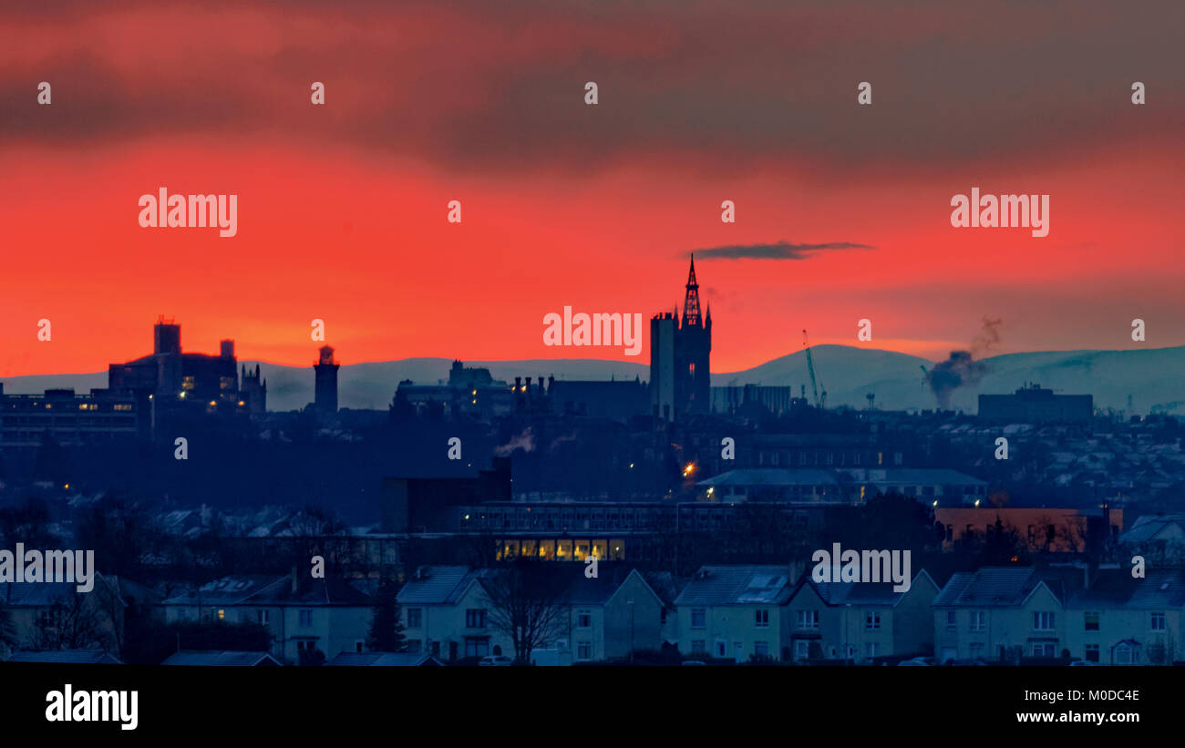 Glasgow, Scotland, Regno Unito 21 Gennaio.UK Meteo: durante la notte di neve con temperature di congelamento dà un colorato alba red sky per la città su Glasgow University di clock tower e tinto hill . Credito traghetto Gerard/Alamy news Foto Stock