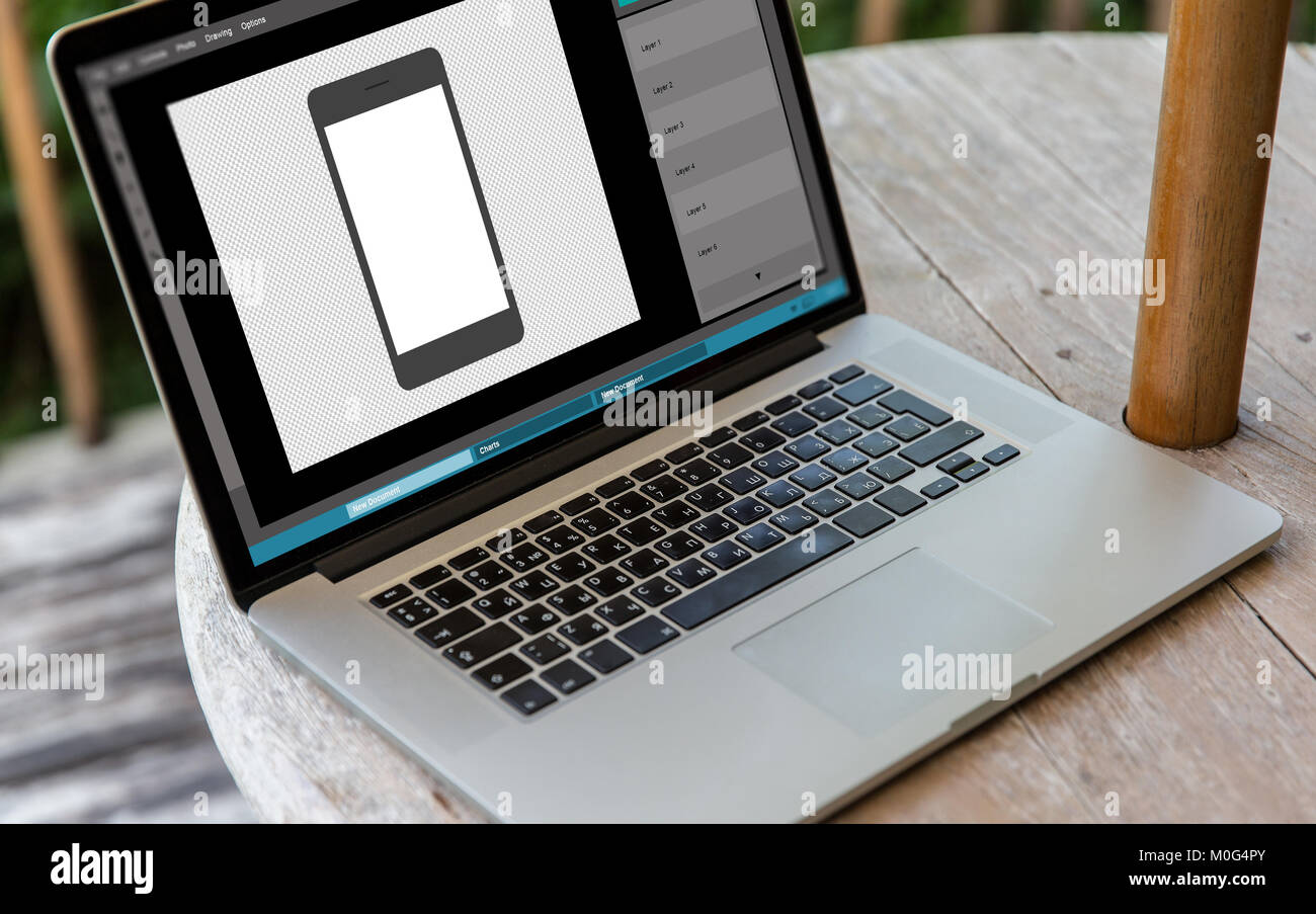 Computer portatile con immagine dello smartphone in editor di grafica Foto Stock