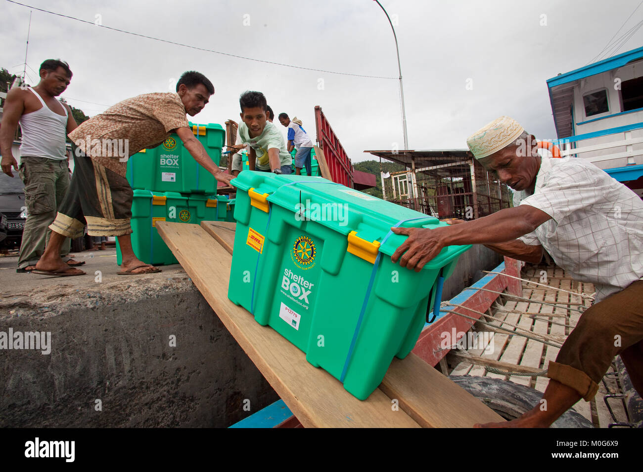 Caricamento di ShelterBoxes su di una barca destinata per le isole Mentawi seguendo il 2010 tsunami Foto Stock