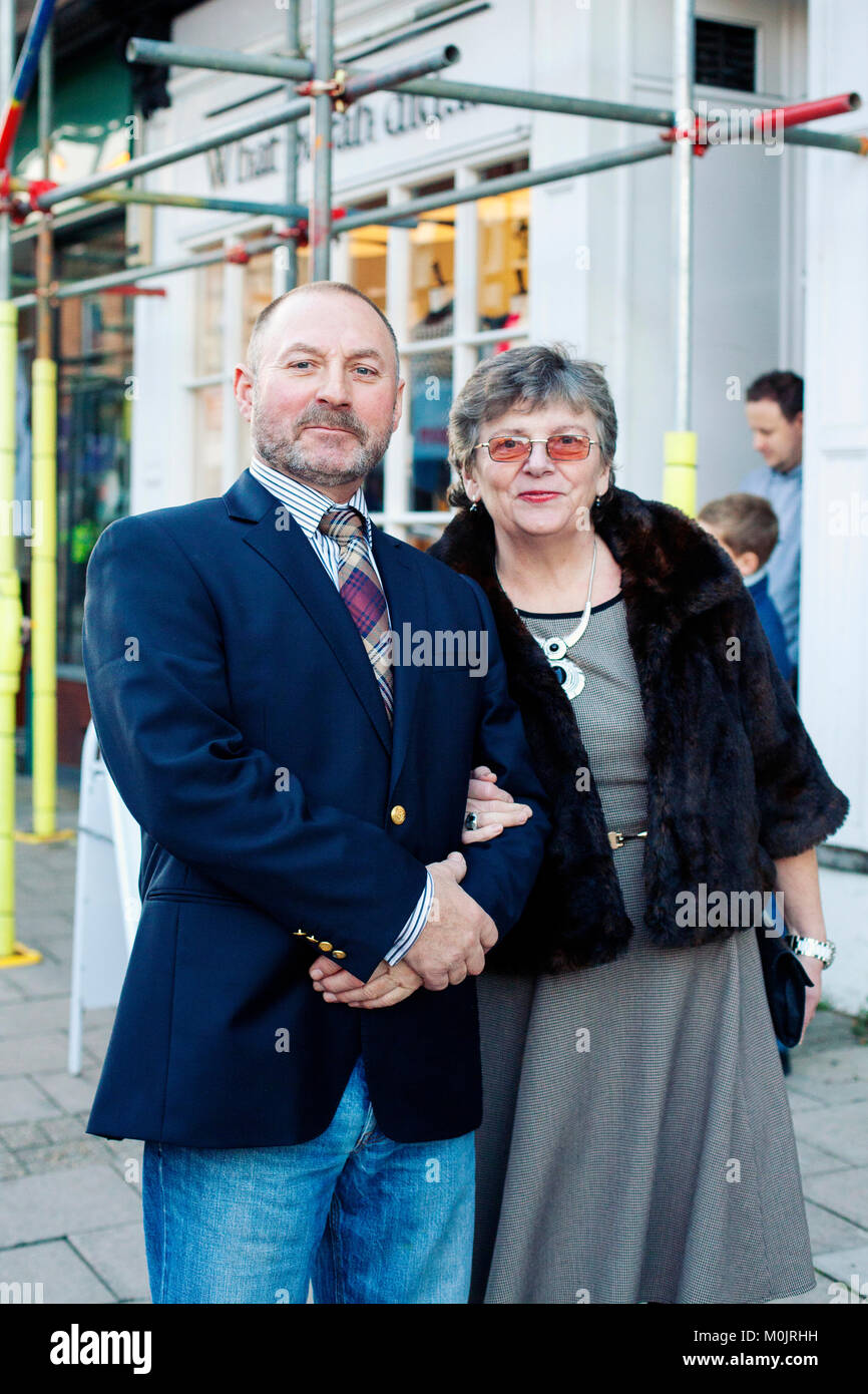 Coppia matura vestita in posa per un ritratto - uomo anziano e donna, nella loro domenica meglio pronto a cena, di fronte all'edificio. Foto Stock