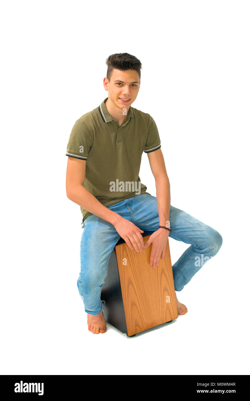 Giovane ragazzo seduto e pagando in Cajon Foto Stock