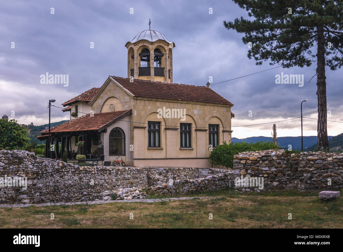 Edificio accanto alla Chiesa Ortodossa Serba di Achilius di Larissa in Arilje città nel distretto di Zlatibor di Serbia sudoccidentale Foto Stock