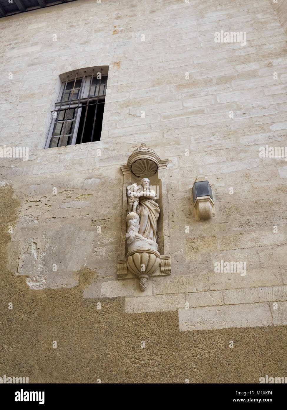 Statua religiosa su un alto muro in Avignon Foto Stock