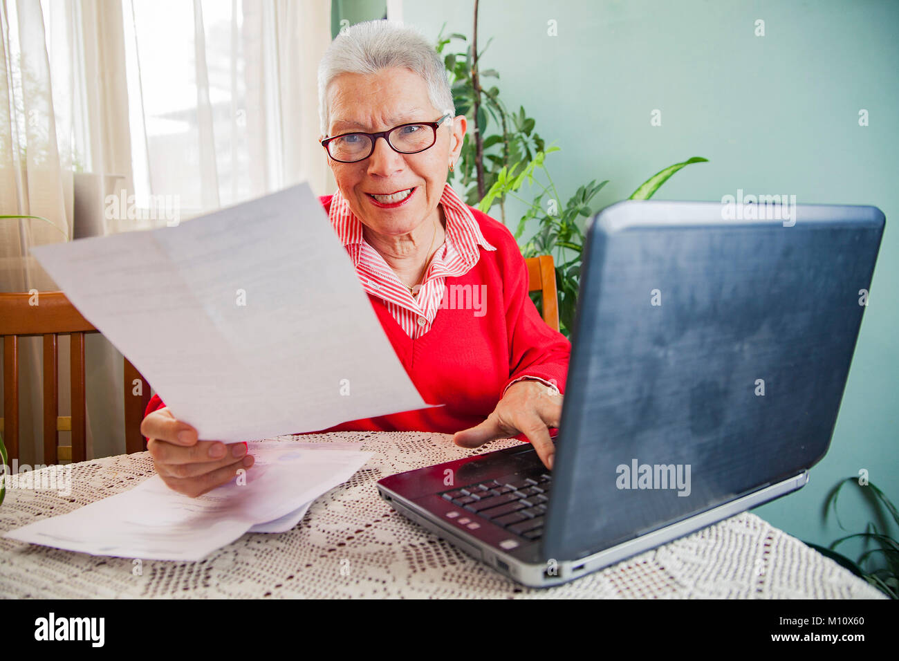 Senior donna oltraggiate con fatture di società di elettricità Foto Stock