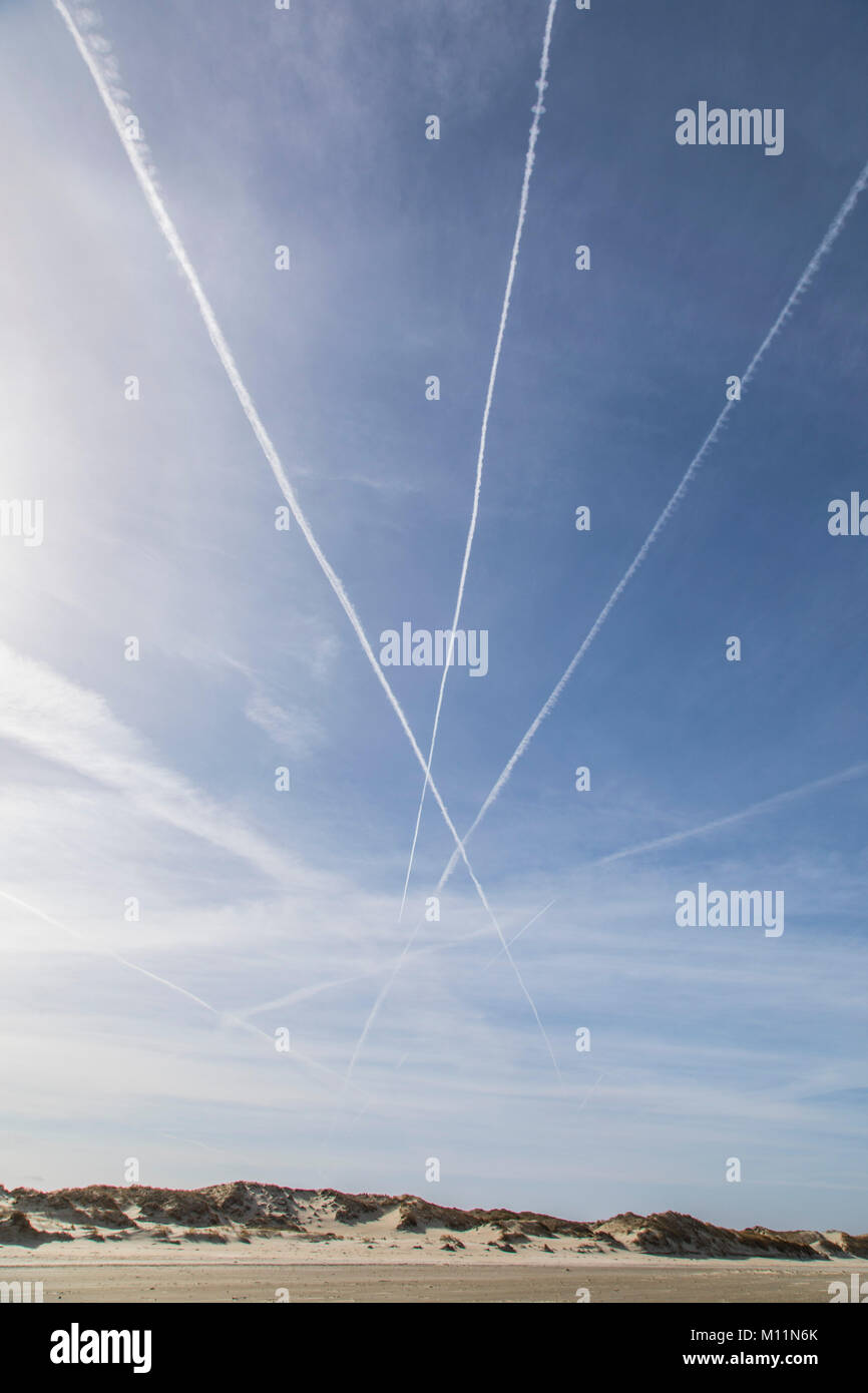 Contrails nel cielo sopra il mare del nord Isola Norderney, Germania, causato dai gas di scarico dei velivoli a getto ad alta altitudine, Foto Stock