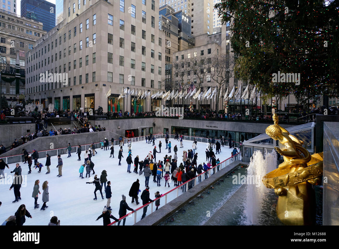La pista di pattinaggio su ghiaccio in Rockefeller Center con la Golden Prometheus scultura in primo piano.vacanze inverno stagione.Manhattan.New York City.USA Foto Stock