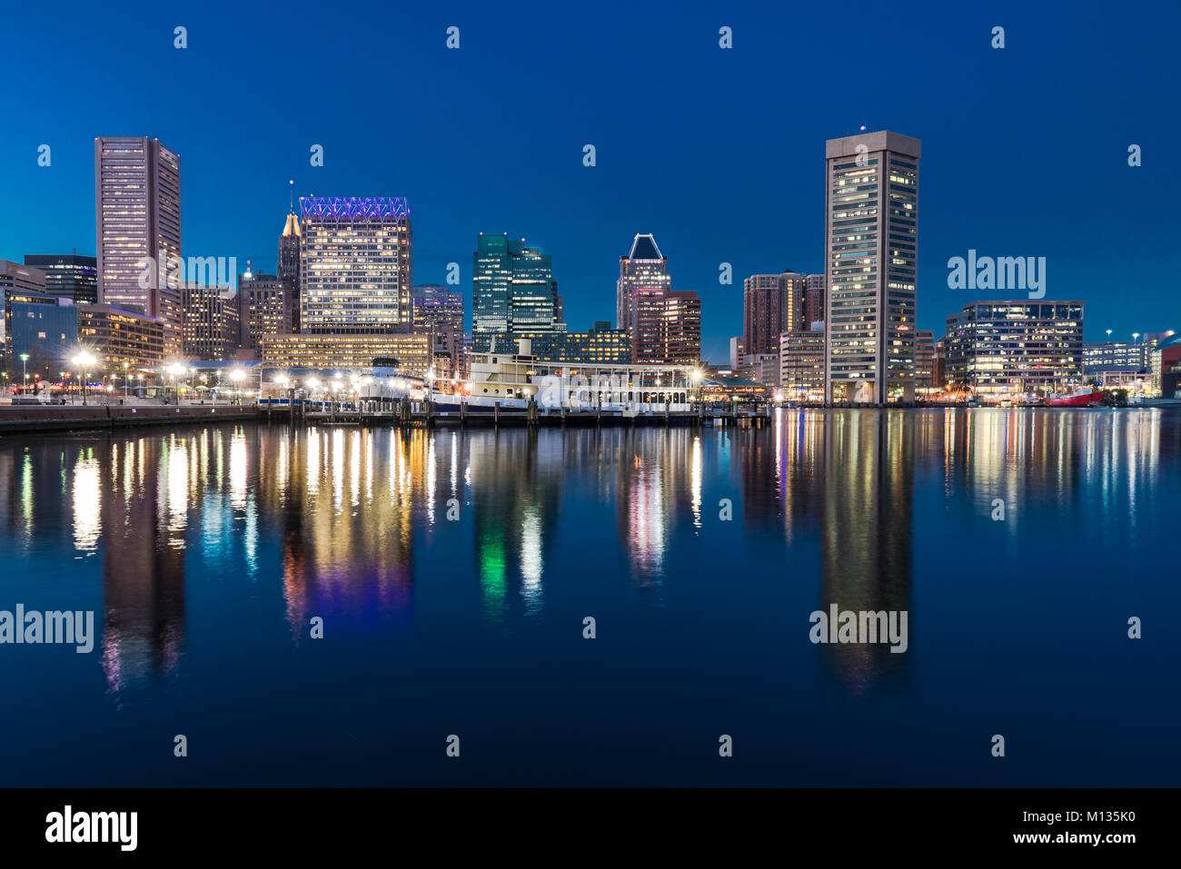 BALTIMORE, MD - 29 dicembre 2014: Baltimore skyline di notte dalla riflessione di Porto Interno Foto Stock