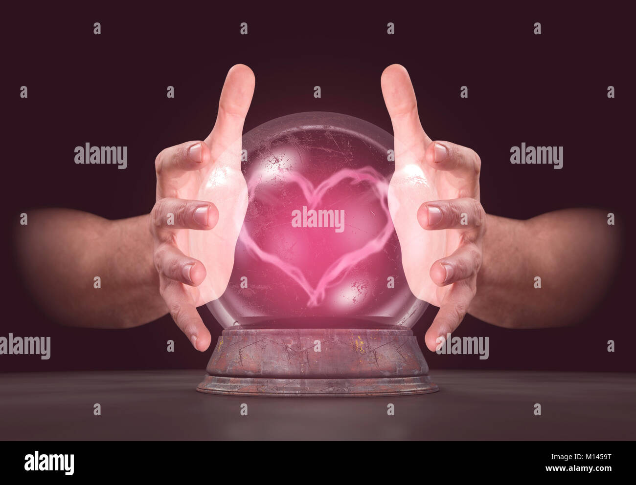 Una coppia di maschi che circonda le mani una sfera di cristallo prestidigitazione fino a rosa a forma di cuore il vapore isolato su un buio di sfondo per studio Foto Stock