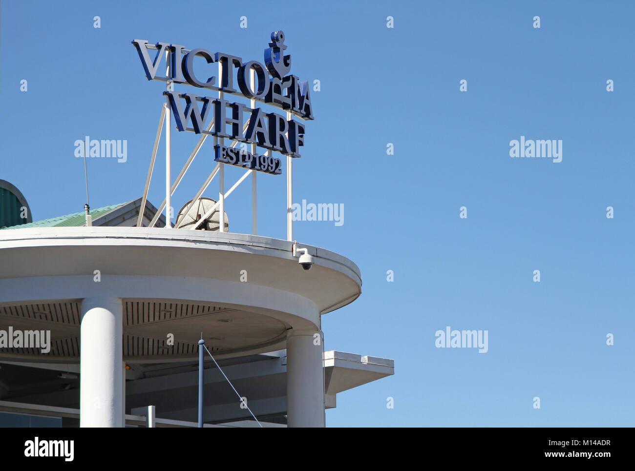 Victoria Wharf segno su un balcone contro il cielo blu al Vicoria Wharf Centro Commerciale (fondata nel 1992), V&A Waterfront, Città del Capo, Westertn Cape Foto Stock
