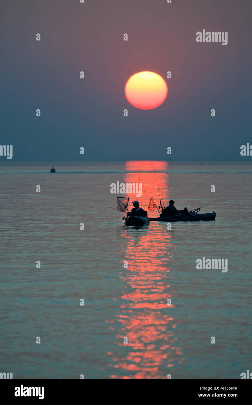 I Paesi Bassi, Zierikzee, i pescatori in ciclo-kayak con motore elettrico. Il tramonto. Foto Stock