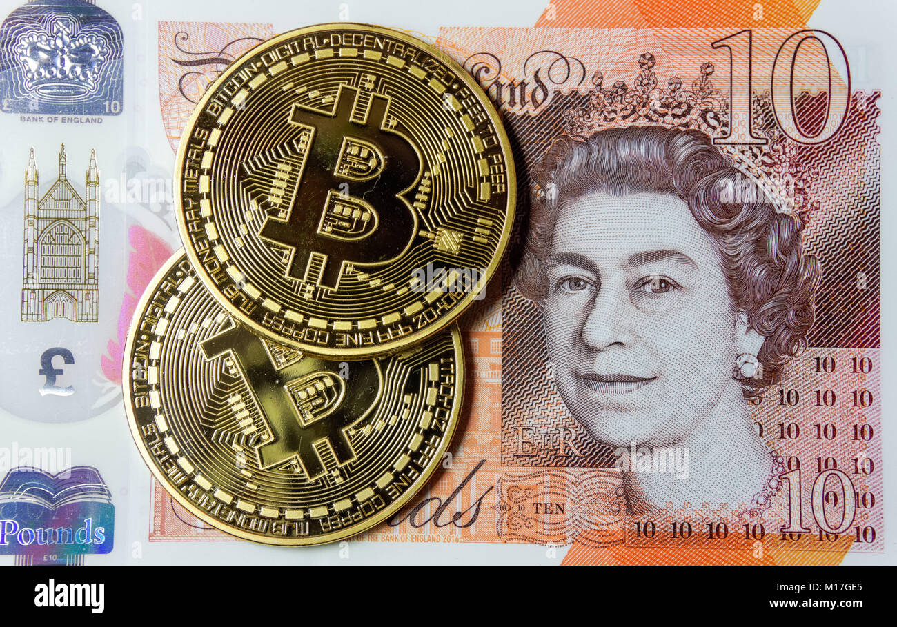 Bitcoin cryptocurrency monete su dieci pound nota Foto Stock