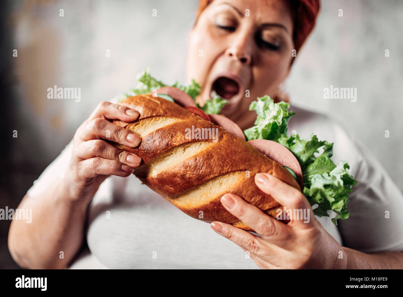 Grasso donna mangia sandwich, sovrappeso e bulimic. Uno stile di vita poco salutare. Obesità Foto Stock