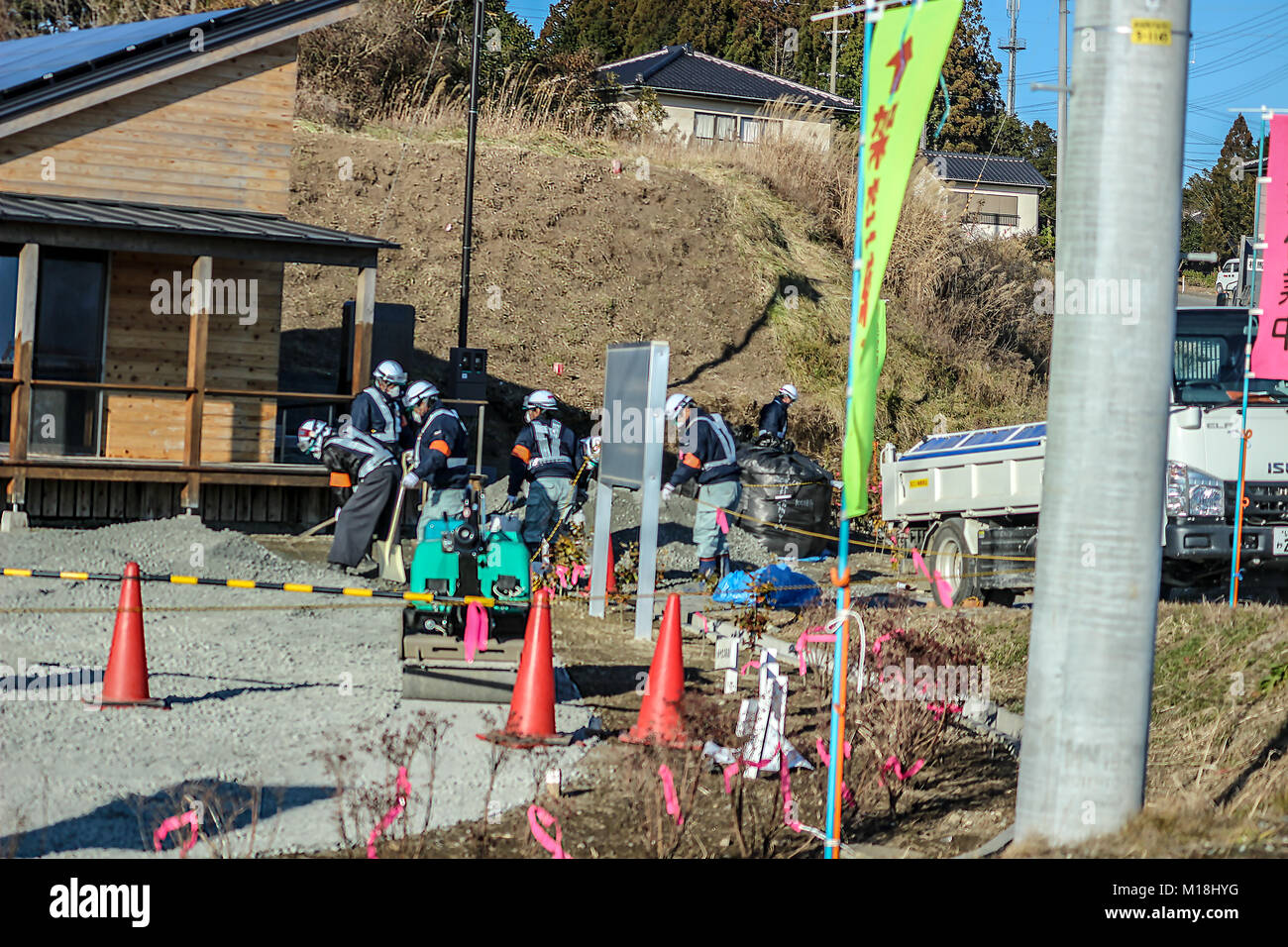 (16 gennaio, 2016 Namie, Fukushima, Giappone) la decontaminazione dei lavoratori fossero pulizia di terreni contaminati. La ricostruzione della città Namie dalle conseguenze dello tsunami è stato il ritardo dovuto al suo status di zona di evacuazione tuttavia da 31, Marzo 2017 in poi, rimpatriati sono in grado di vivere in aree decontaminato in giù. Foto Stock