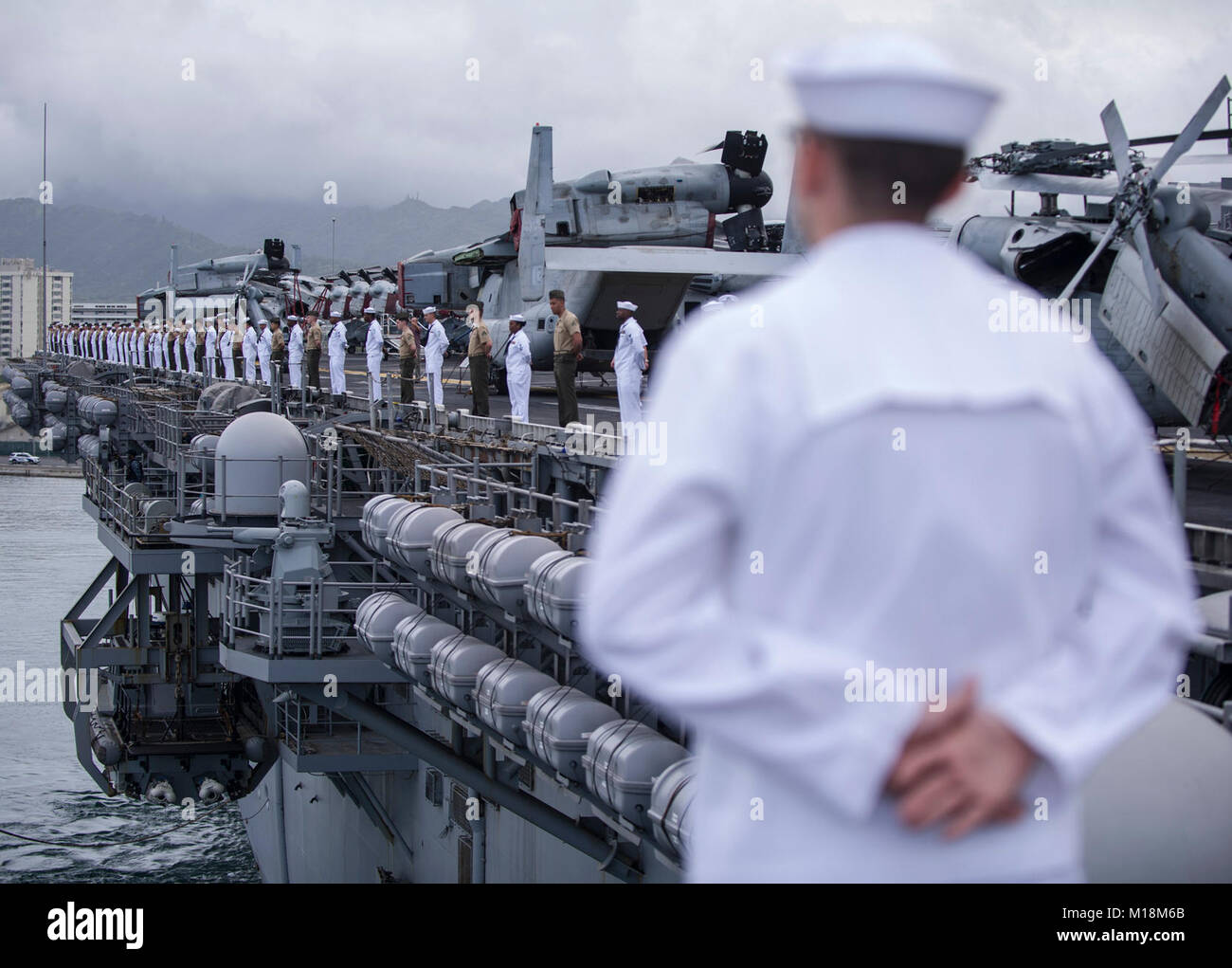 BASE COMUNE DI PEARL HARBOR-HICKAM (GEN. 25, 2018) Marinai e Marines a bordo dell'assalto anfibio nave USS America (LHA 6) uomo le rotaie come la nave parte Base comune Harbor-Hickam perla dopo una porta programmata visita. America, parte dell'America anfibio gruppo pronto, con avviato xv Marine Expeditionary Unit, è di ritorno da 7 mesi di distribuzione per gli Stati Uniti 3a, 5 e 7 settori della flotta delle operazioni. (U.S. Navy Foto Stock