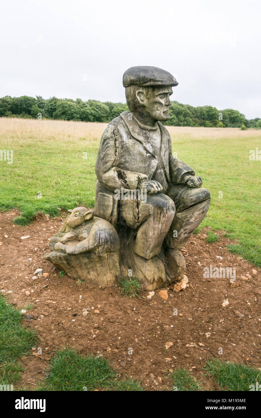 Scultura in legno di un pastore sulla North Downs, Kent, Regno Unito. Area di straordinaria bellezza naturale Foto Stock