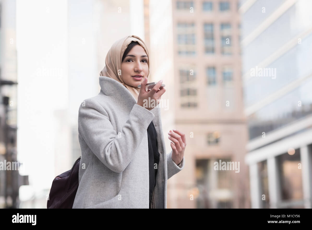 Donna in hijab parlando al telefono cellulare Foto Stock