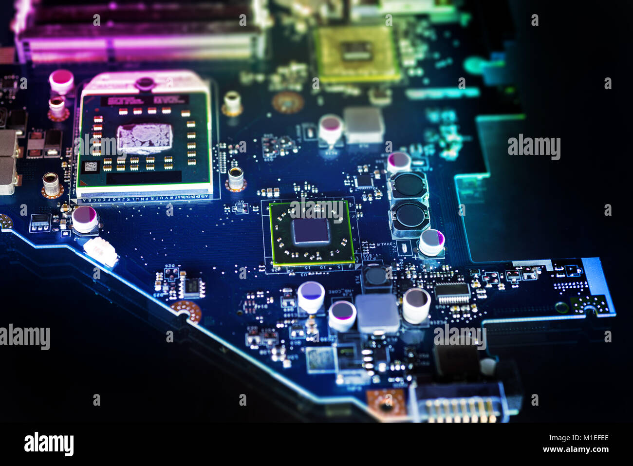 Microchip su una scheda a circuito stampato su sfondo scuro Foto Stock
