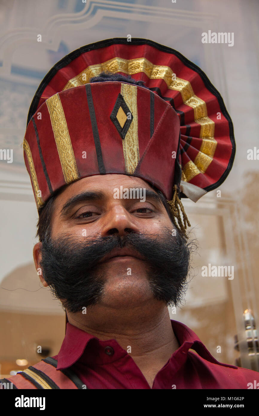 Elegantemente vestito portiere la guardia di sicurezza al di fuori di un hotel di Delhi, India Foto Stock