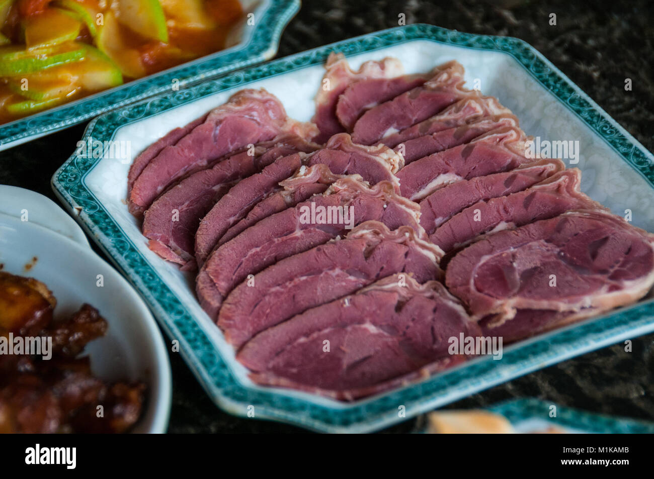 Home cucinato cibo cinese nella zona rurale di Xi'an, Shaanxi Province, Cina. Piatto principale bollito di manzo fette con un piatto di hongshaorou (brasati di carne di maiale) Foto Stock