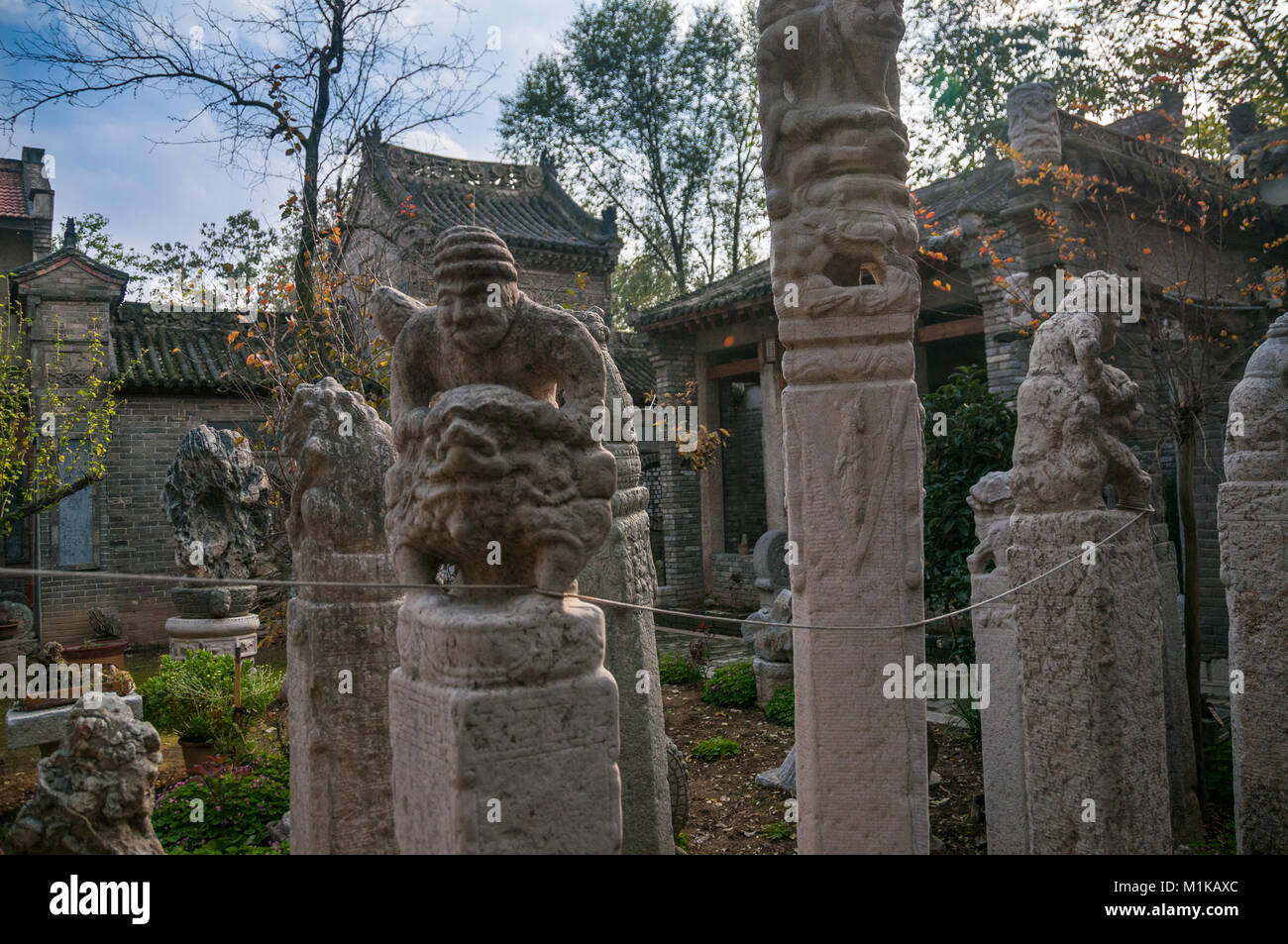 Un post statua di un vecchio uomo che cavalca un leone come creatura circondato da altri. Parte di Wu Jianguo della collezione di antichi si trova nella parte rurale Foto Stock