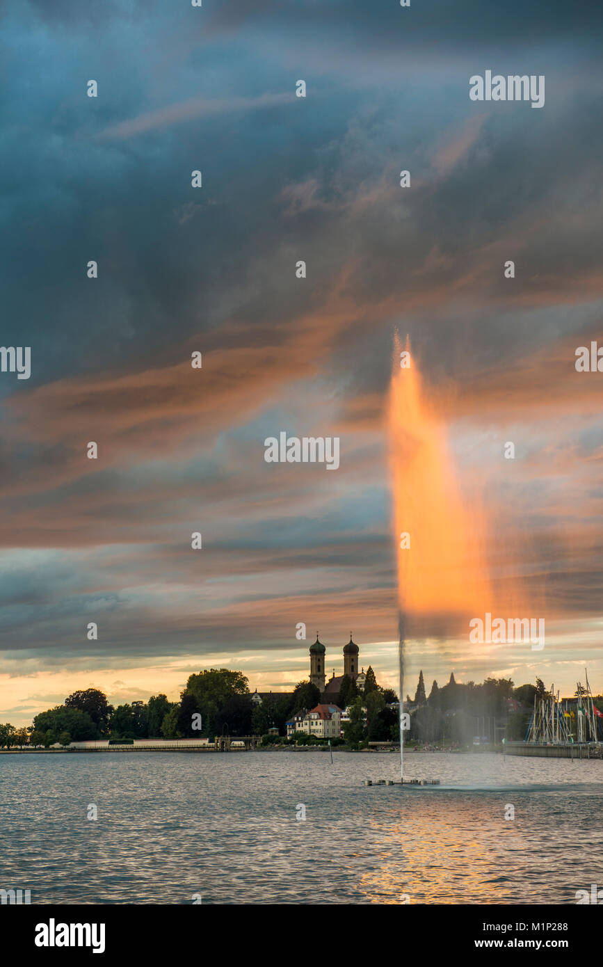 Fontana e thunderclouds al tramonto,Schlosskirche in background,Friedrichshafen,Lago di Costanza,Baden-Württemberg Foto Stock