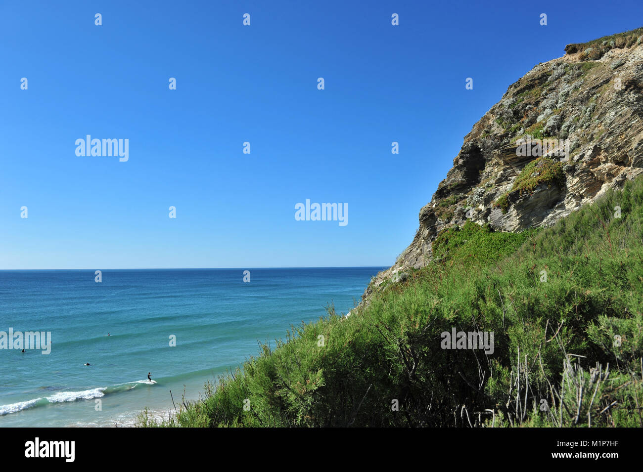 Surfers sotto le scogliere, Watergate Bay, Cornwall, Regno Unito Foto Stock