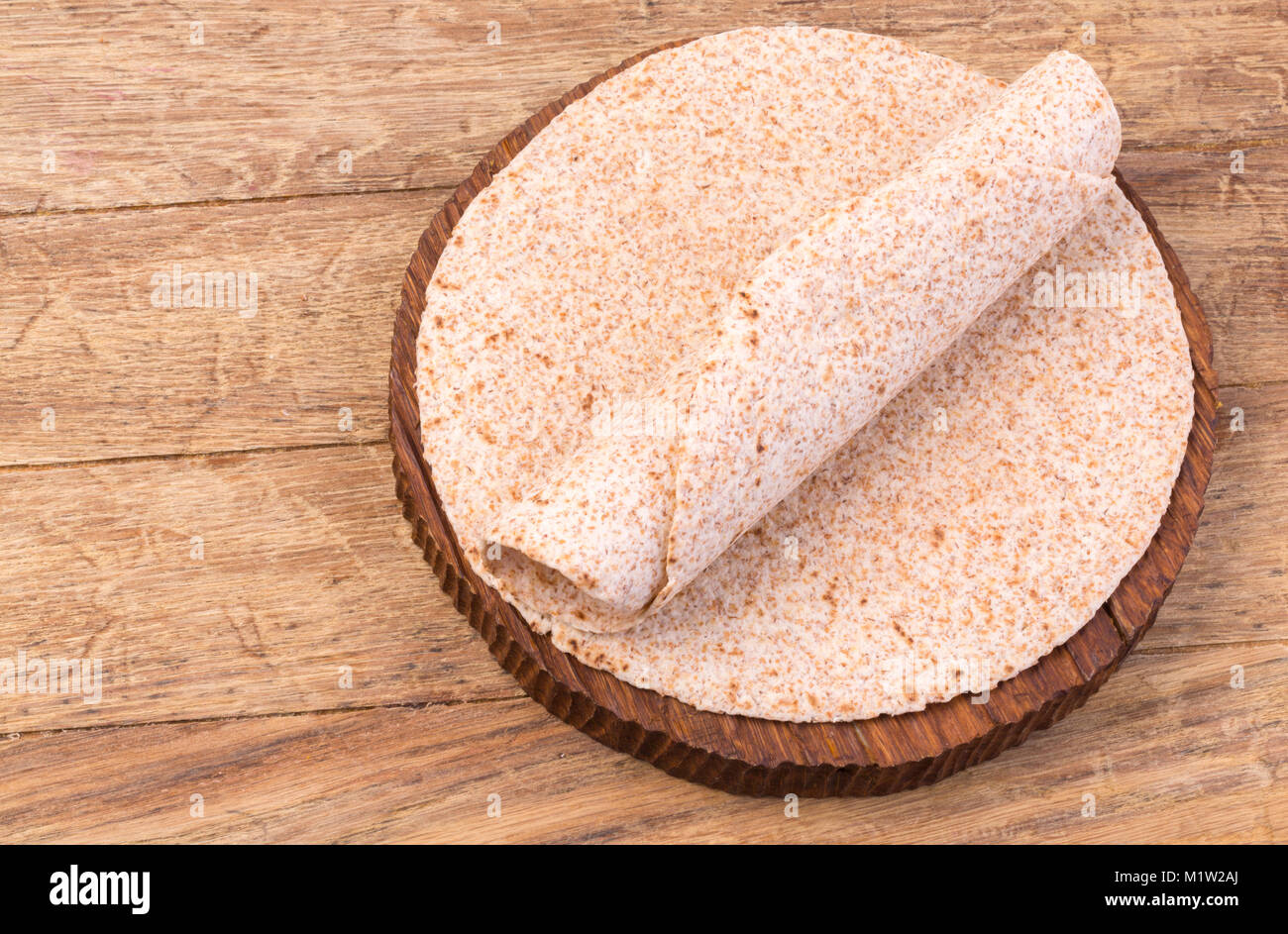 Pila di fatti in casa di grano intero tortilla di farina sul tavolo di legno sfondo Foto Stock