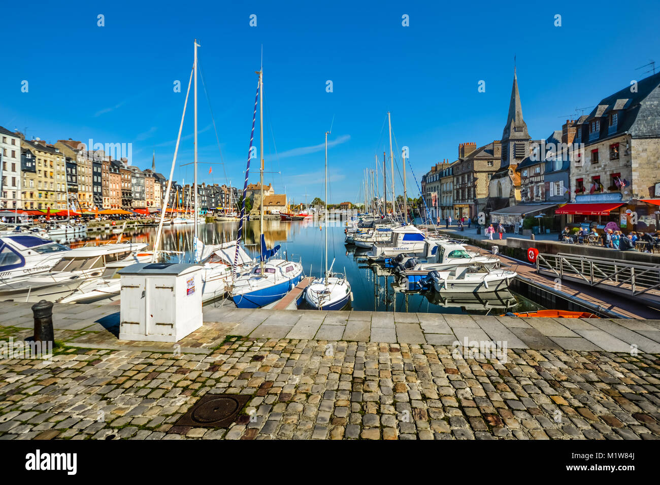 La colorata e storica cittadina balneare di Honfleur Francia in Normandia con pittoreschi edifici, barche e il mare del Canale della Manica Foto Stock