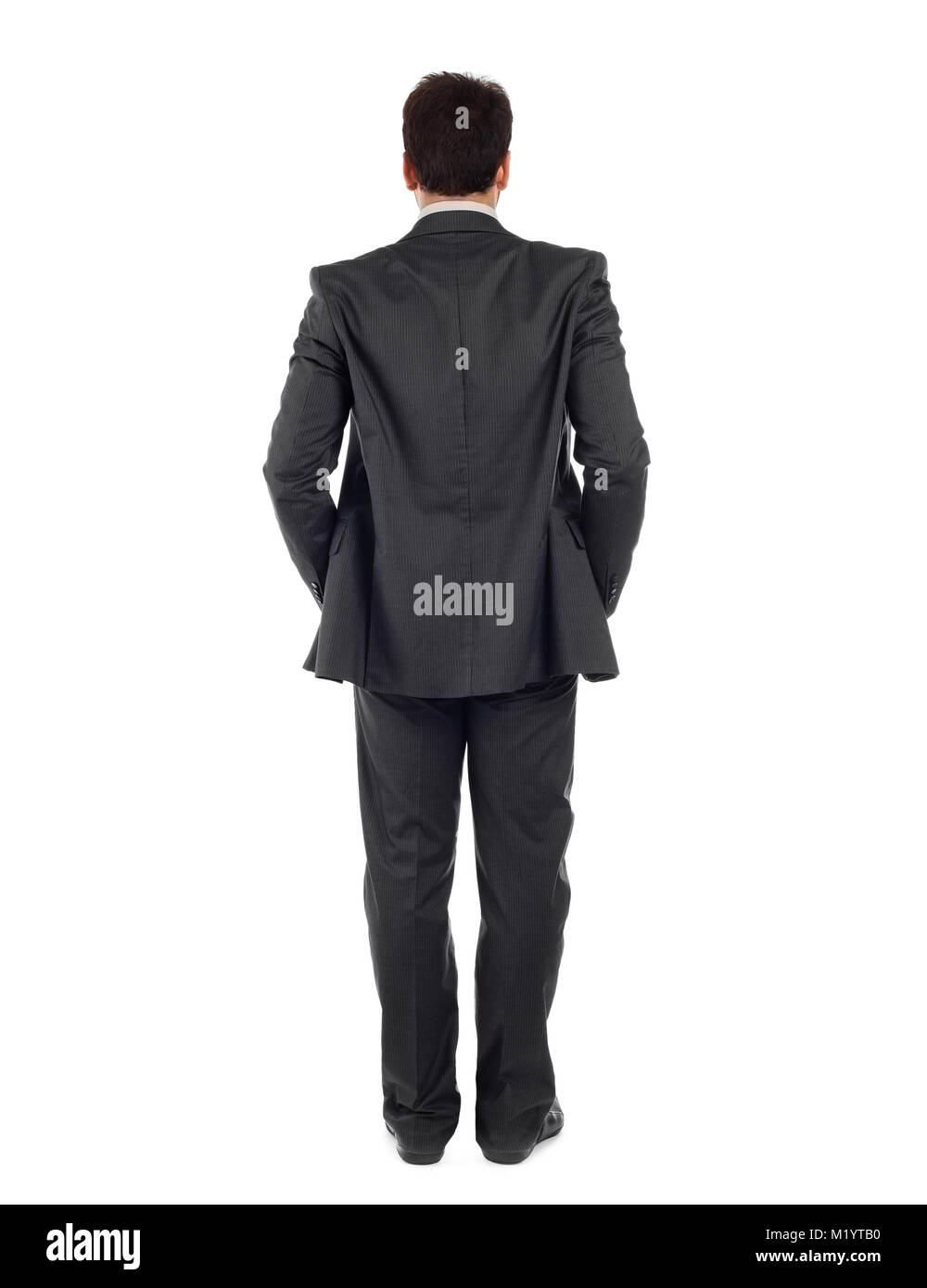 Vista posteriore del corpo intero di un business man in black suit isolati su sfondo bianco. Foto Stock
