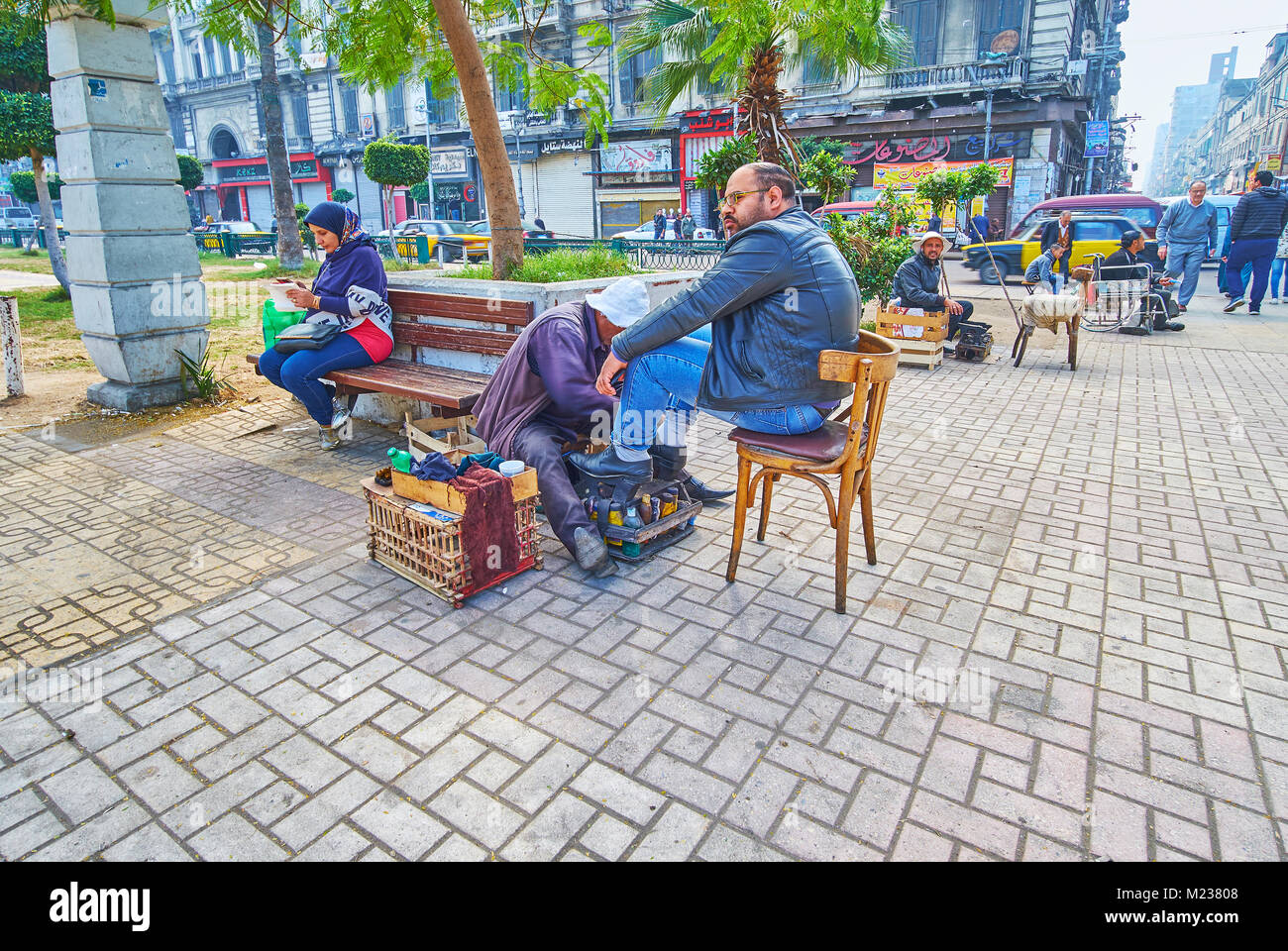 Alessandria, Egitto - 17 dicembre 2017: le numerose shoeshiners offrono i loro servizi in El-Tahrir piazza sempre rumorosa e affollata posto, nel mese di dicembre Foto Stock
