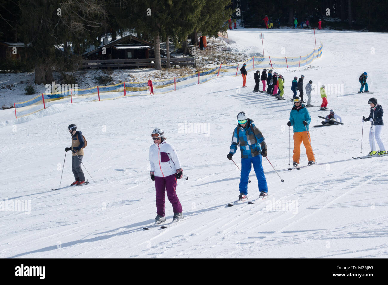 Gli sciatori avente una lezione di sci su piste baby, Niederau, Alpbach, Tirolo, Austria, Europa Foto Stock